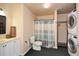 Bathroom including shower, toilet, vanity and in unit washer/dryer at 6065 Nw Gentlewind Court Nw Ct, Powder Springs, GA 30127
