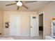 Neutral bedroom featuring ceiling fan, closet, and adjoining room at 6065 Nw Gentlewind Court Nw Ct, Powder Springs, GA 30127