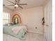 Charming bedroom with a creative rainbow mural, carpet, and plenty of natural light from the window at 6065 Nw Gentlewind Court Nw Ct, Powder Springs, GA 30127
