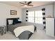 Comfortable bedroom featuring a ceiling fan and a window that brightens up the room at 6065 Nw Gentlewind Court Nw Ct, Powder Springs, GA 30127