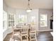 Cozy dining area features hardwood floors, wainscoting, and plenty of natural light from three large windows at 6065 Nw Gentlewind Court Nw Ct, Powder Springs, GA 30127