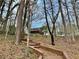 Charming backyard featuring wooden stairs, lush trees, and a glimpse of the home's deck at 89 Paces Lakes Pt, Dallas, GA 30157