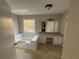 Bathroom featuring a soaking tub, dual sinks, a skylight, and tiled floors at 89 Paces Lakes Pt, Dallas, GA 30157