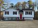 Charming single-Gathering home with a red front door and a well-maintained front yard at 89 Paces Lakes Pt, Dallas, GA 30157