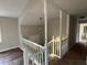 Hallway with decorative posts, carpeted floors, and neutral paint tones at 89 Paces Lakes Pt, Dallas, GA 30157