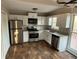 Well-lit kitchen with stainless steel appliances, white cabinets, and a modern design at 89 Paces Lakes Pt, Dallas, GA 30157