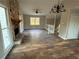 Bright living room featuring a stone fireplace, wood floors, and stairs with white railings at 89 Paces Lakes Pt, Dallas, GA 30157