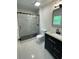 Modern bathroom with black fixtures, elegant tile and new vanity at 1570 Childress Sw Dr, Atlanta, GA 30311