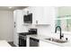 Modern kitchen features white cabinets, stainless steel appliances and granite countertops at 1570 Childress Sw Dr, Atlanta, GA 30311