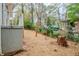 Backyard area featuring wood fence, mature trees, and green foliage at 3436 Misty Valley Rd, Decatur, GA 30032