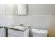 Compact bathroom with granite-look countertop, white cabinets, and tile walls at 3436 Misty Valley Rd, Decatur, GA 30032