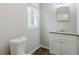 Bathroom featuring a granite countertop, modern vanity, and a window for natural light at 3436 Misty Valley Rd, Decatur, GA 30032