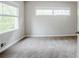 Cozy bedroom with neutral carpet, white trim and walls, and a view of nature outside the window at 3436 Misty Valley Rd, Decatur, GA 30032