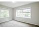 Bright bedroom featuring neutral walls, plush carpeting, and two large windows offering ample natural light at 3436 Misty Valley Rd, Decatur, GA 30032