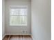 Compact bedroom with sleek vinyl floors and a window offering a view of lush greenery outside at 3436 Misty Valley Rd, Decatur, GA 30032