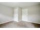 Bedroom with carpet and two white doors, creating a bright and clean living space at 3436 Misty Valley Rd, Decatur, GA 30032