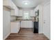 Compact kitchen features white cabinets, granite countertops, and modern black appliances at 3436 Misty Valley Rd, Decatur, GA 30032