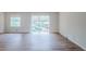 Spacious living room with hardwood floors and large windows, providing ample natural light at 3436 Misty Valley Rd, Decatur, GA 30032