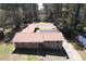 A captivating aerial view of a brick home with an extensive roof, showcasing its unique layout and spacious surroundings at 5159 Covington Hwy, Decatur, GA 30035