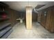 Unfinished basement space with wood paneling, ideal for storage or customization at 5169 Covington Hwy, Decatur, GA 30035