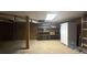 Spacious basement featuring storage shelves and a white refrigerator at 5169 Covington Hwy, Decatur, GA 30035