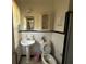 Cozy bathroom featuring a pedestal sink, tiled walls, and a mirrored cabinet at 5169 Covington Hwy, Decatur, GA 30035