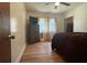 Serene bedroom with hardwood floors, a large window, neutral walls, and a ceiling fan at 5169 Covington Hwy, Decatur, GA 30035