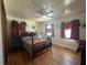 Comfortable bedroom featuring hardwood floors, ceiling fan, and a decorative bed frame at 5169 Covington Hwy, Decatur, GA 30035