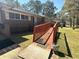 Charming brick home featuring a wheelchair ramp and a well-maintained lawn at 5169 Covington Hwy, Decatur, GA 30035