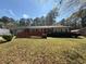 Charming single-story brick home featuring a wheelchair ramp and well-maintained front lawn with mature trees at 5169 Covington Hwy, Decatur, GA 30035