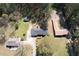 An aerial view showing the home's wooded surroundings and neighborhing homes in the residential area at 5181 Covington Hwy, Decatur, GA 30035