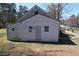 The rear of the home features a siding exterior and a modest yard backing onto a busy road at 5181 Covington Hwy, Decatur, GA 30035