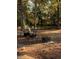 An outdoor sitting area is perfect for relaxing and enjoying the serene backyard setting with mature trees at 5470 Chanterella Sw Ct, Lilburn, GA 30047