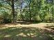 Expansive grassy backyard offers plenty of space for recreation, gardening, and outdoor enjoyment with mature shade trees at 5470 Chanterella Sw Ct, Lilburn, GA 30047