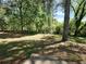Expansive grassy backyard offers plenty of space for recreation, gardening, and outdoor enjoyment with mature shade trees at 5470 Chanterella Sw Ct, Lilburn, GA 30047
