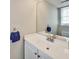 Bright bathroom with white vanity, modern sink, and large mirror reflecting natural light at 5470 Chanterella Sw Ct, Lilburn, GA 30047