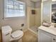 This bathroom features a shower and a toilet at 5470 Chanterella Sw Ct, Lilburn, GA 30047