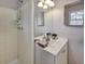 This bathroom features a shower and a vanity sink at 5470 Chanterella Sw Ct, Lilburn, GA 30047