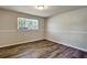 Bedroom featuring hardwood floors and a window at 5470 Chanterella Sw Ct, Lilburn, GA 30047