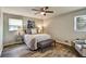 This bedroom features a ceiling fan and two windows at 5470 Chanterella Sw Ct, Lilburn, GA 30047