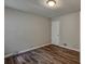 This bedroom features wood-look flooring, neutral paint, and a flush mount light fixture at 5470 Chanterella Sw Ct, Lilburn, GA 30047