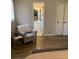 View of the bedroom featuring hardwood-style flooring and an accent chair at 5470 Chanterella Sw Ct, Lilburn, GA 30047