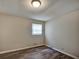 This bedroom has hardwood floors and a window at 5470 Chanterella Sw Ct, Lilburn, GA 30047