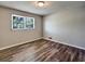 Bedroom featuring hardwood floors and a window at 5470 Chanterella Sw Ct, Lilburn, GA 30047