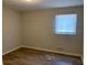 This bedroom has hardwood floors and a window at 5470 Chanterella Sw Ct, Lilburn, GA 30047