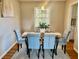 Stylish dining room with a glass table, decorative art, and natural light at 5470 Chanterella Sw Ct, Lilburn, GA 30047