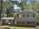 Charming two-story home featuring a brick and siding facade, complemented by lush landscaping and a well-manicured lawn at 5470 Chanterella Sw Ct, Lilburn, GA 30047