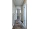 View of the hallway featuring hardwood-style flooring and several entryways at 5470 Chanterella Sw Ct, Lilburn, GA 30047