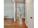Inviting interior hallway featuring hardwood floors and neutral wall colors, leading to other rooms in the home at 5470 Chanterella Sw Ct, Lilburn, GA 30047