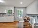 Efficient kitchen with white cabinetry, hardwood floors, and a breakfast bar at 5470 Chanterella Sw Ct, Lilburn, GA 30047